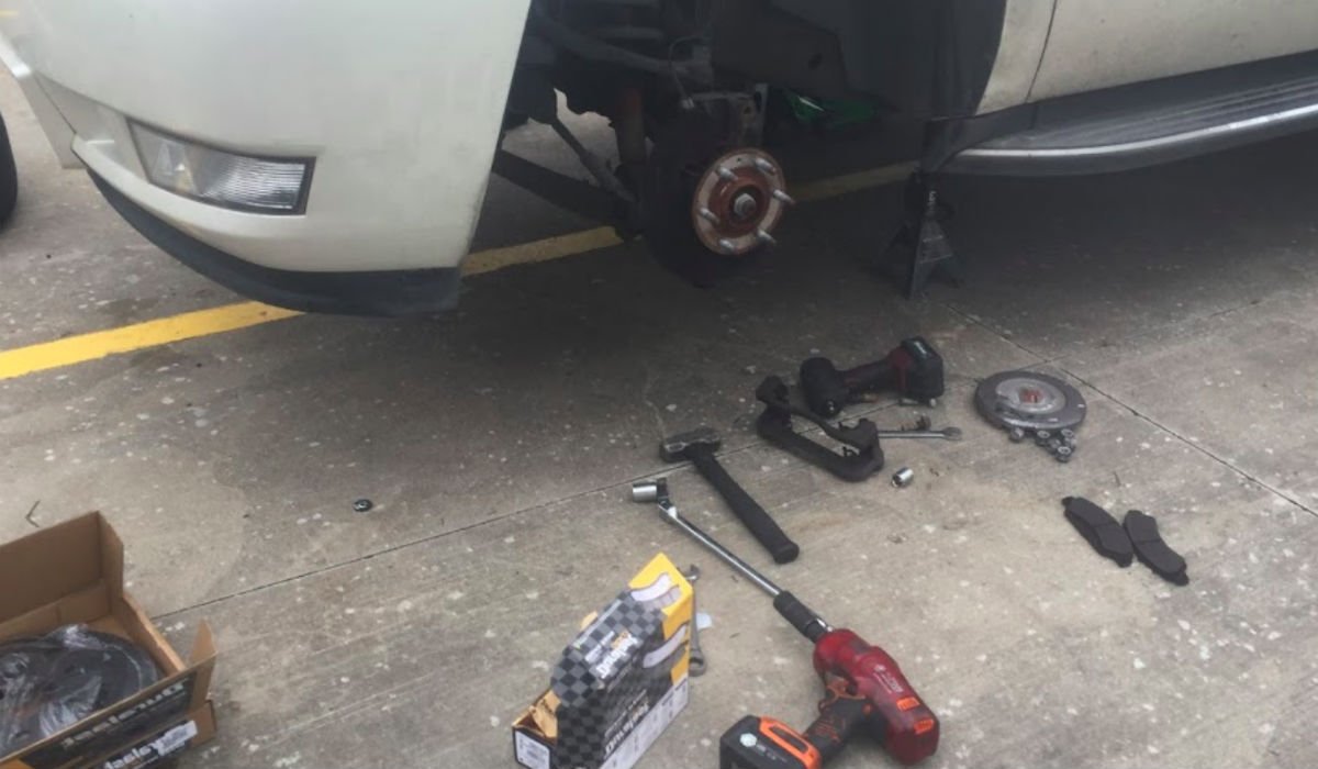 Photo of auto brake job repair on white Chevy pickup.
