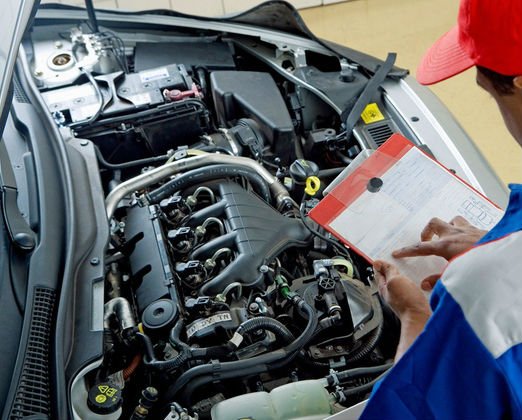 Photo of Mobile Mechanic Huntington Beach writing info on clipboard regarding a mobile auto inspection.